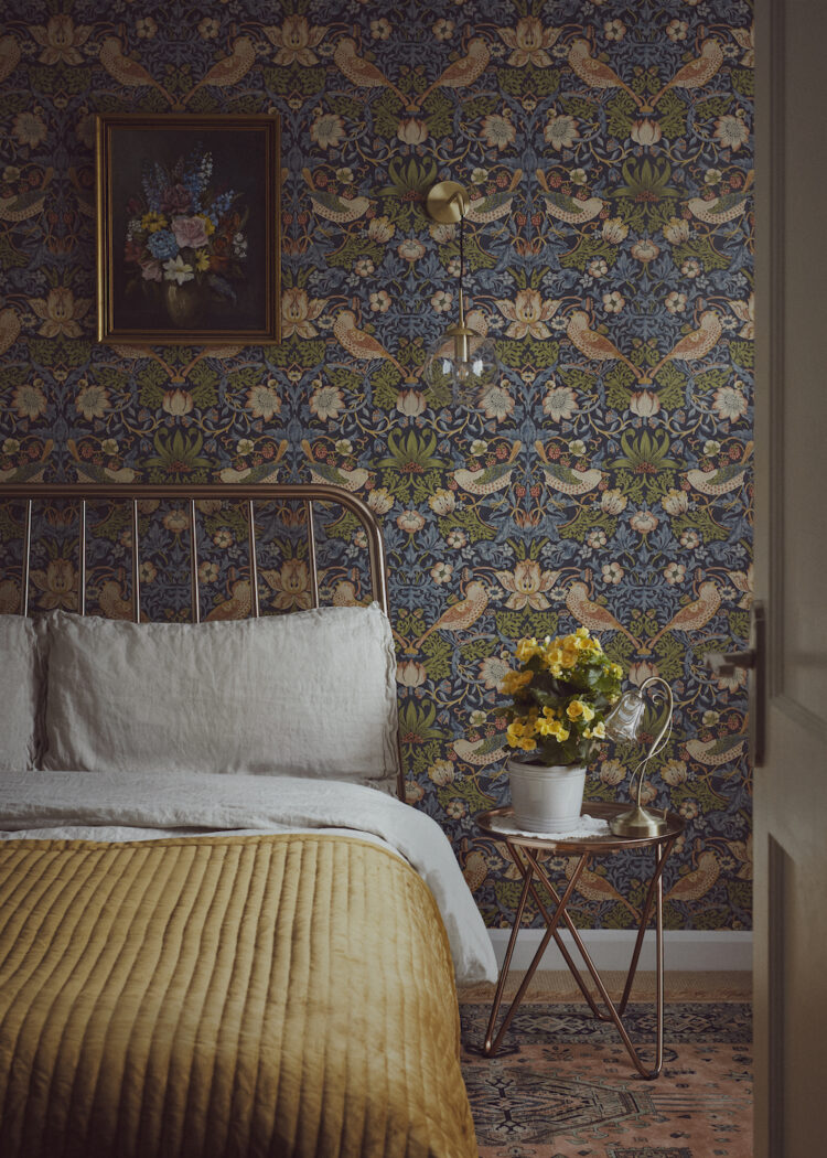 Floral bedroom interior with William Morris print wallpaper