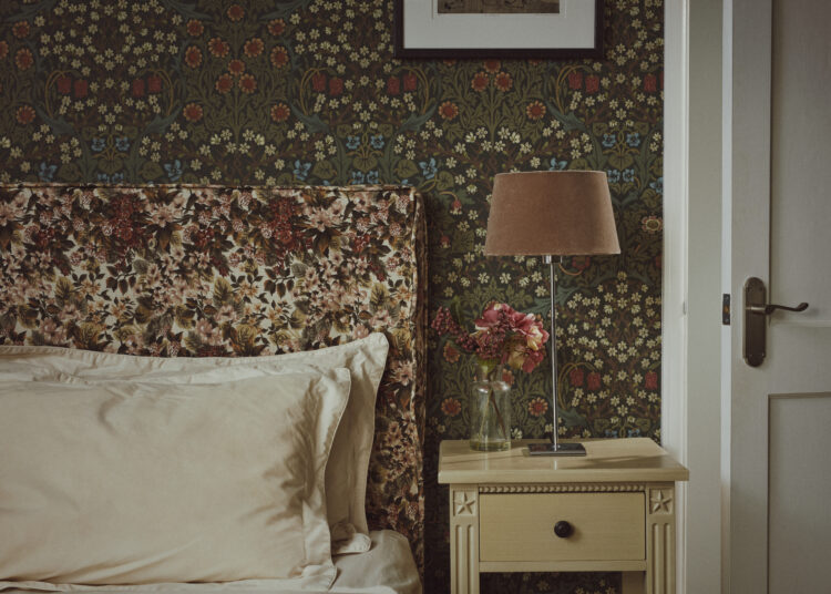 Floral bedroom interior with William Morris print wallpaper