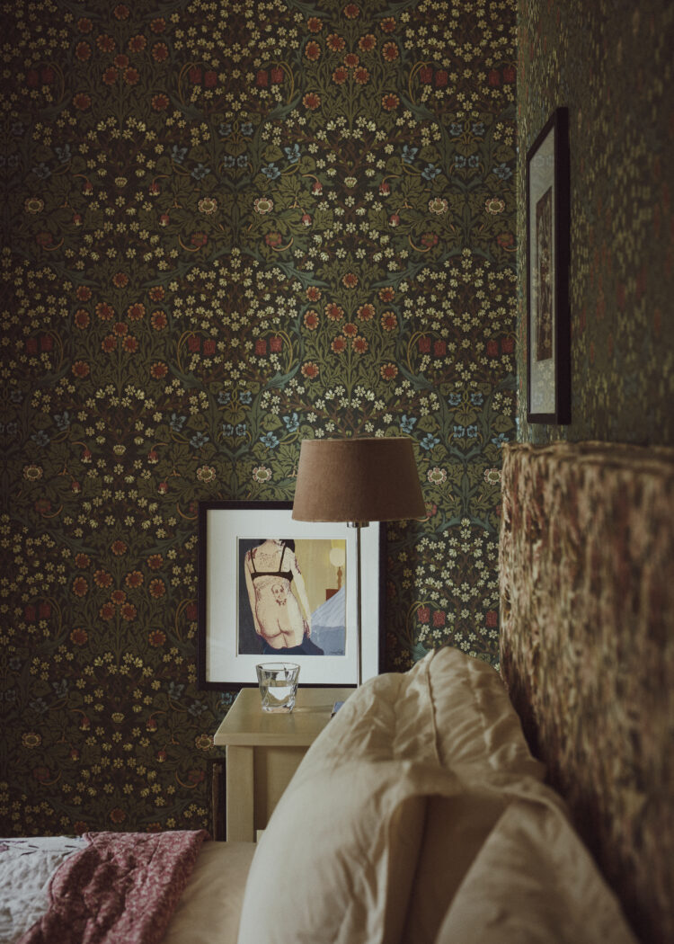 Floral bedroom interior with William Morris print wallpaper