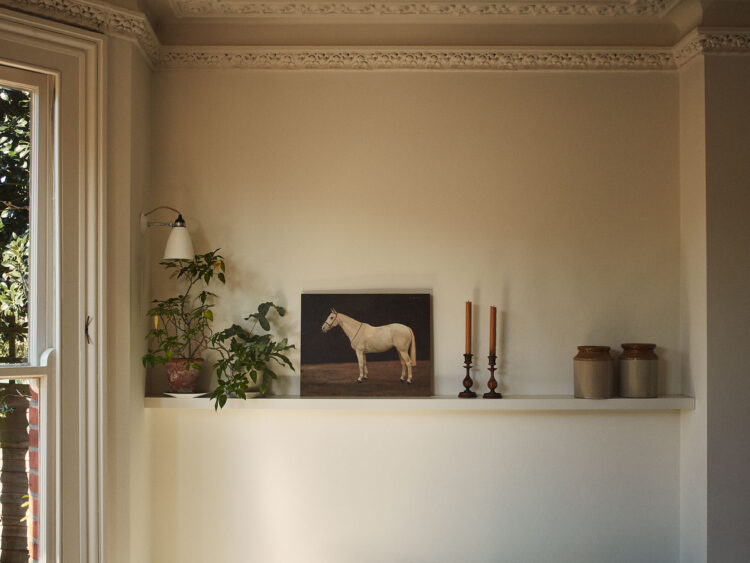 Shelf with lamp, horse painting and candle sticks