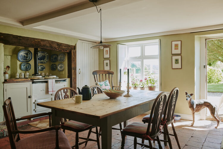 Wooden kitchen dining table with Aga in background