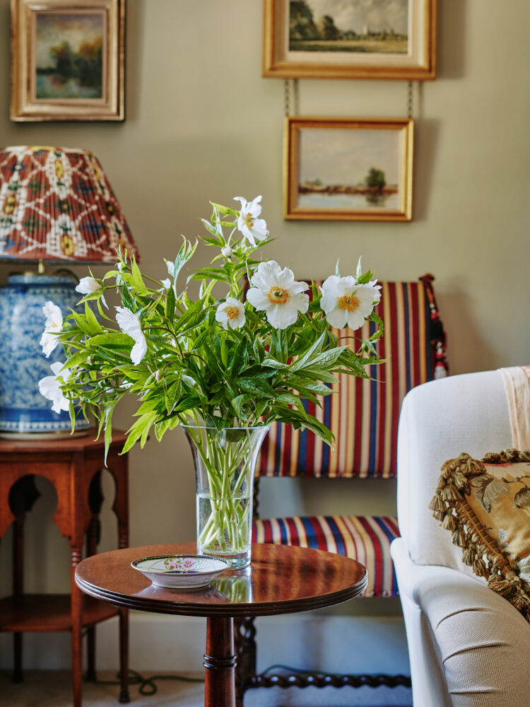 Floral arrangement in glass vase on wood table